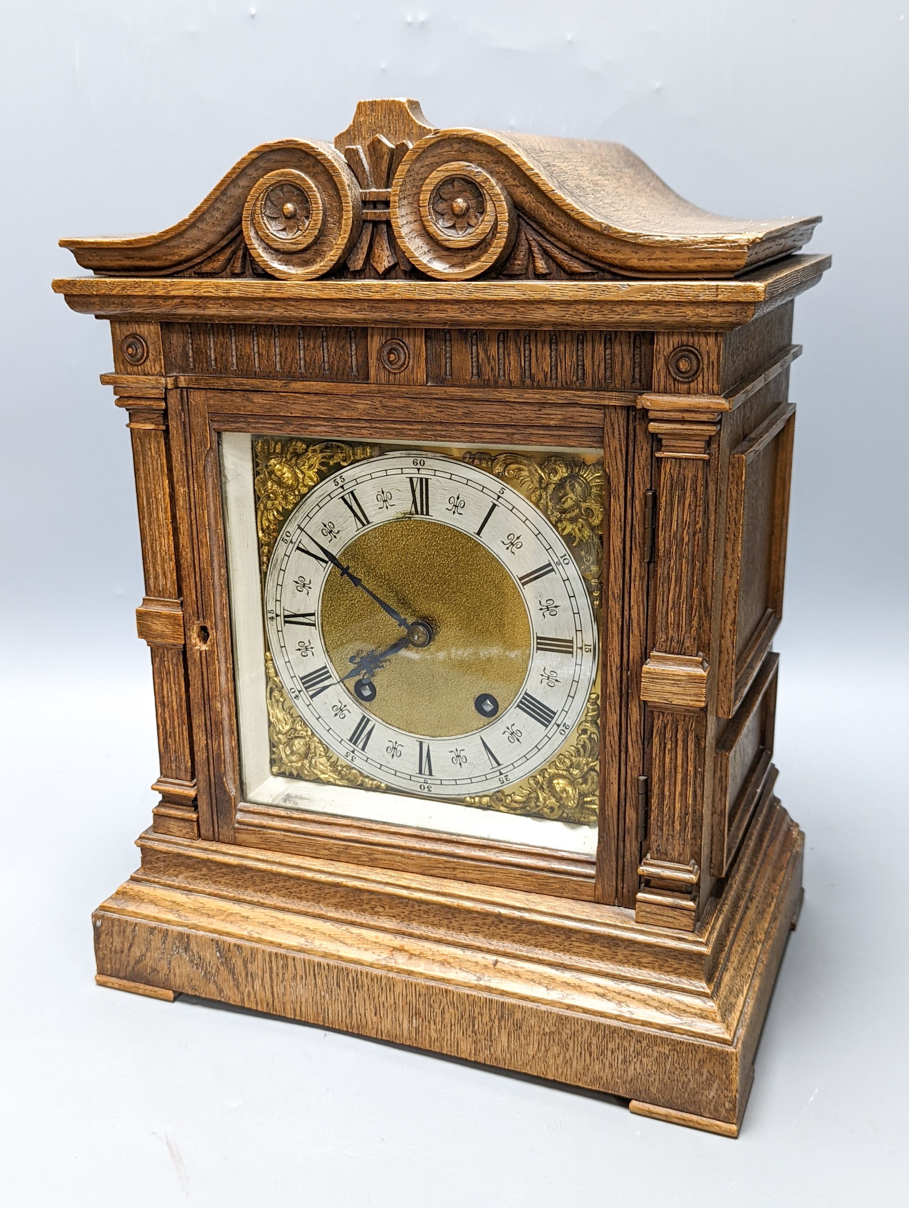 A late 19th century German oak cased eight day mantel clock